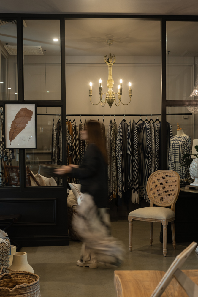 Homewares store owner and her dog inside her boutique beneath a chandelier – personal branding photography by MelCreative